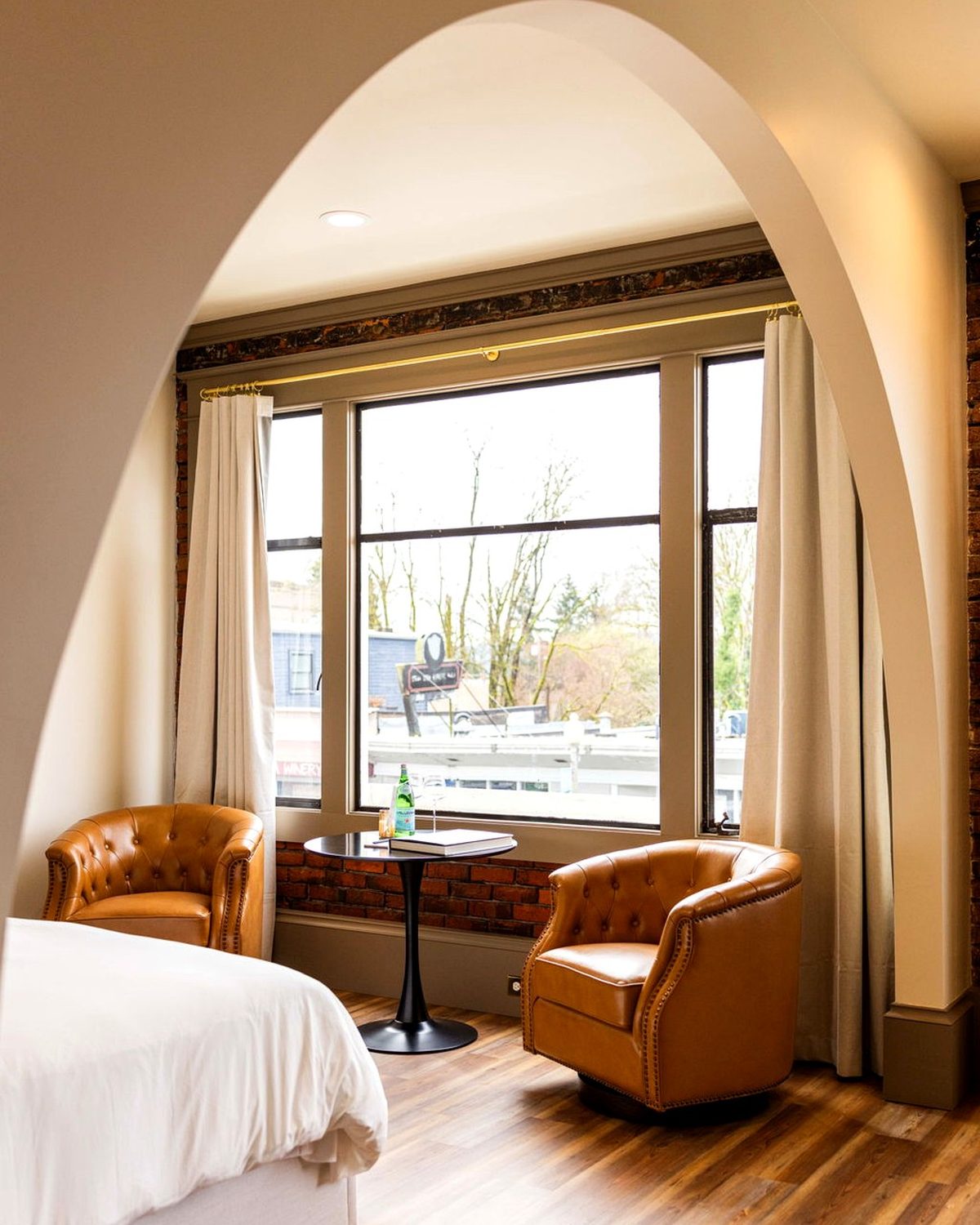A suite inside the Union Block with an arched window and river-view brick